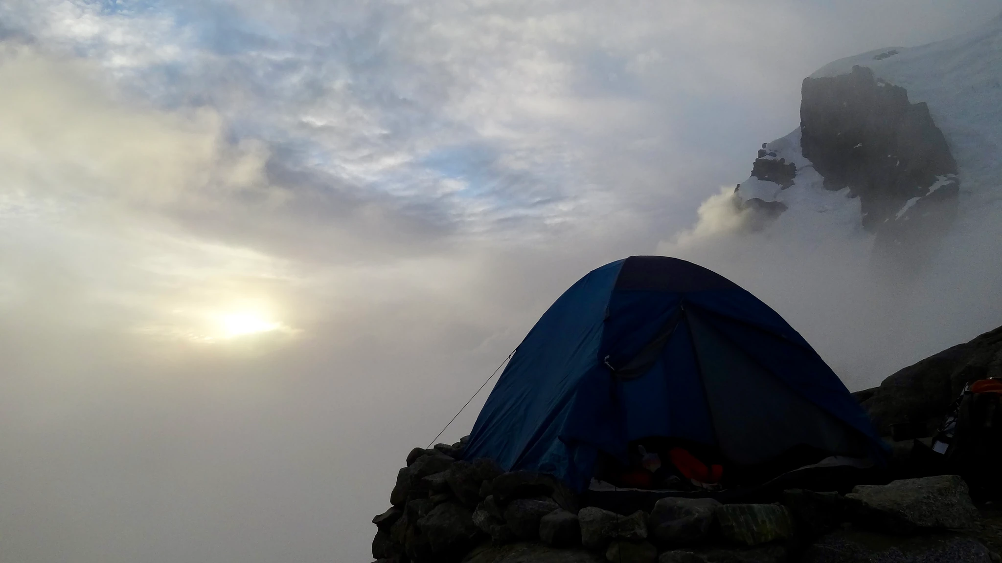 Our blue tent on a rocky ledge at the bivouac before the Mount Tutoko summit attempt.