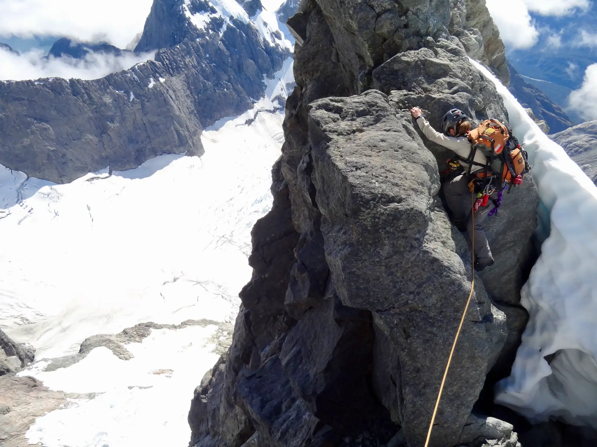 Moving together on the rope through the rocky section on Mount Tutoko.