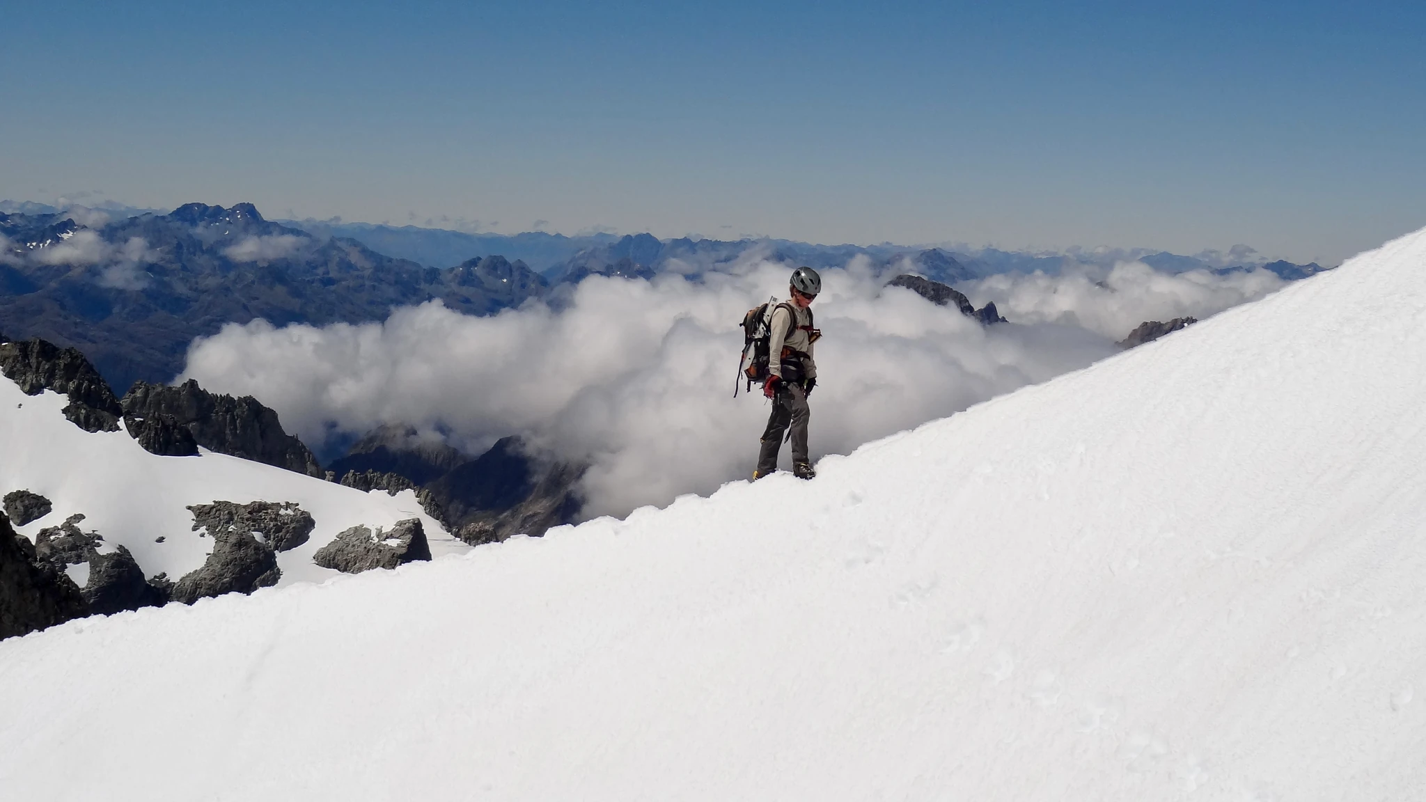 Joanna tiptoeing on the snow ridge of Mount Tutoko.
