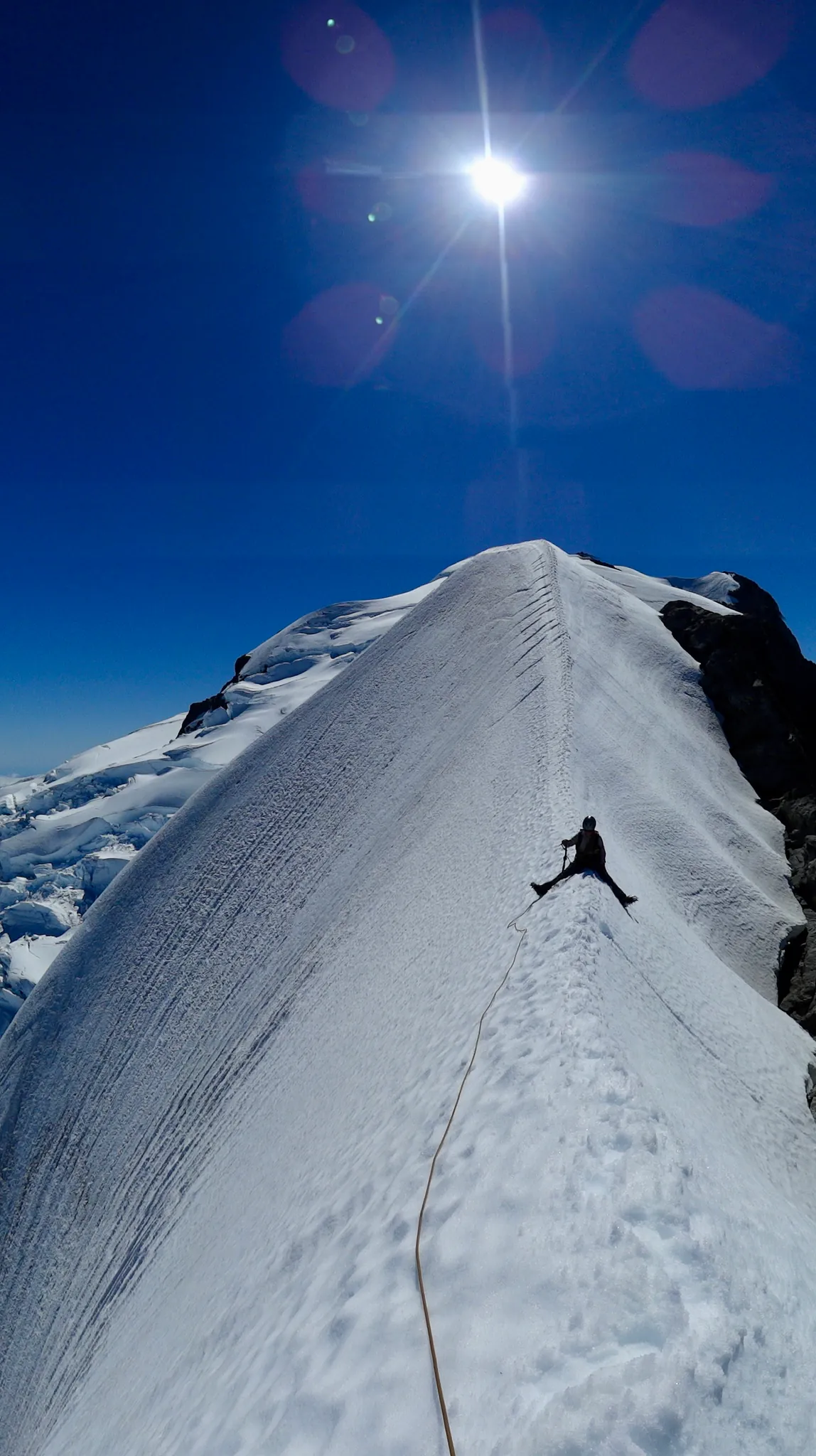 Joanna sitting astride the ridge of Mount Tutoko.