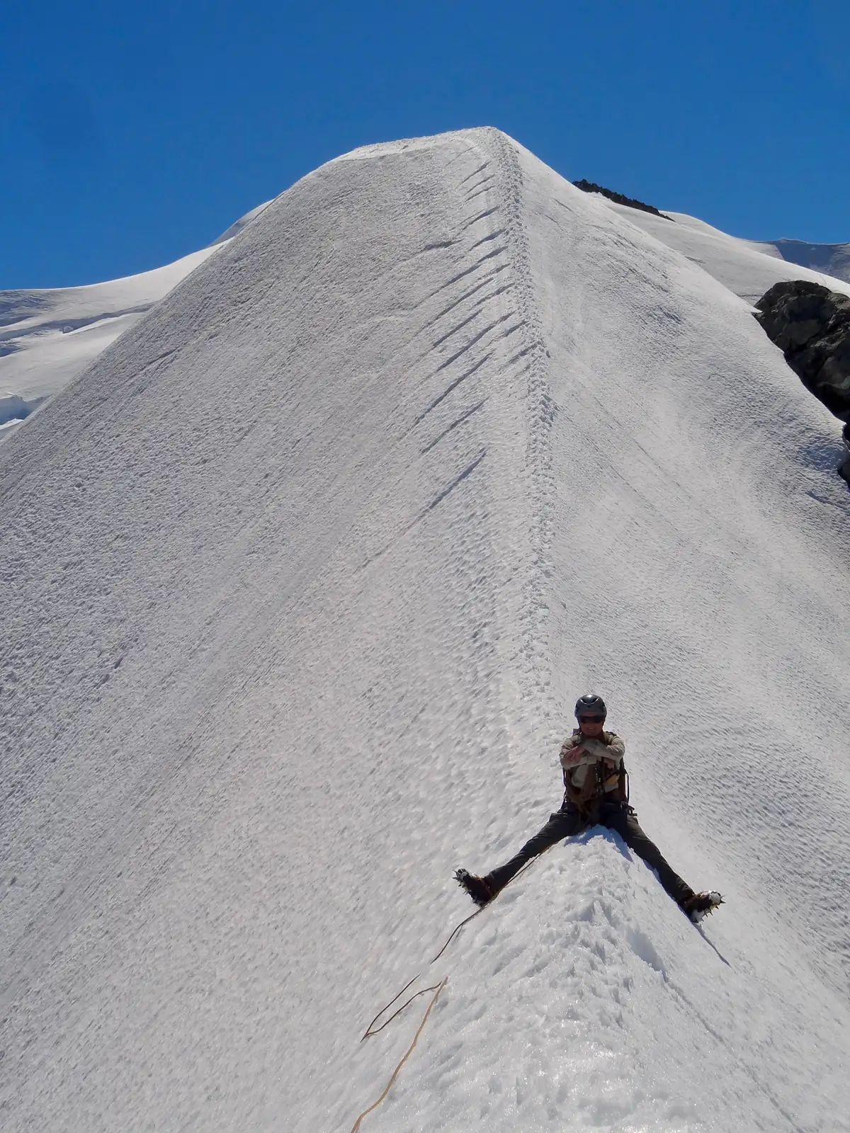 Joanna sitting astride the ridge of Mount Tutoko.
