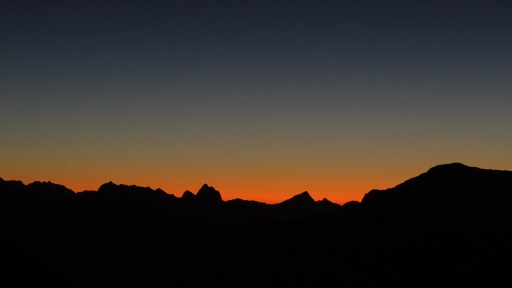 A jagged skyline against an orange sky.