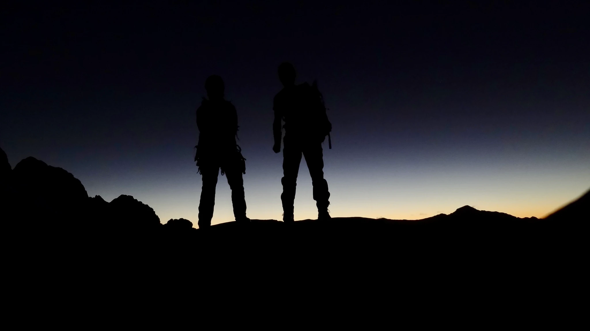 Finally back at the tent on Mount Tutoko, silhouetted against the colourful sky after sunset.