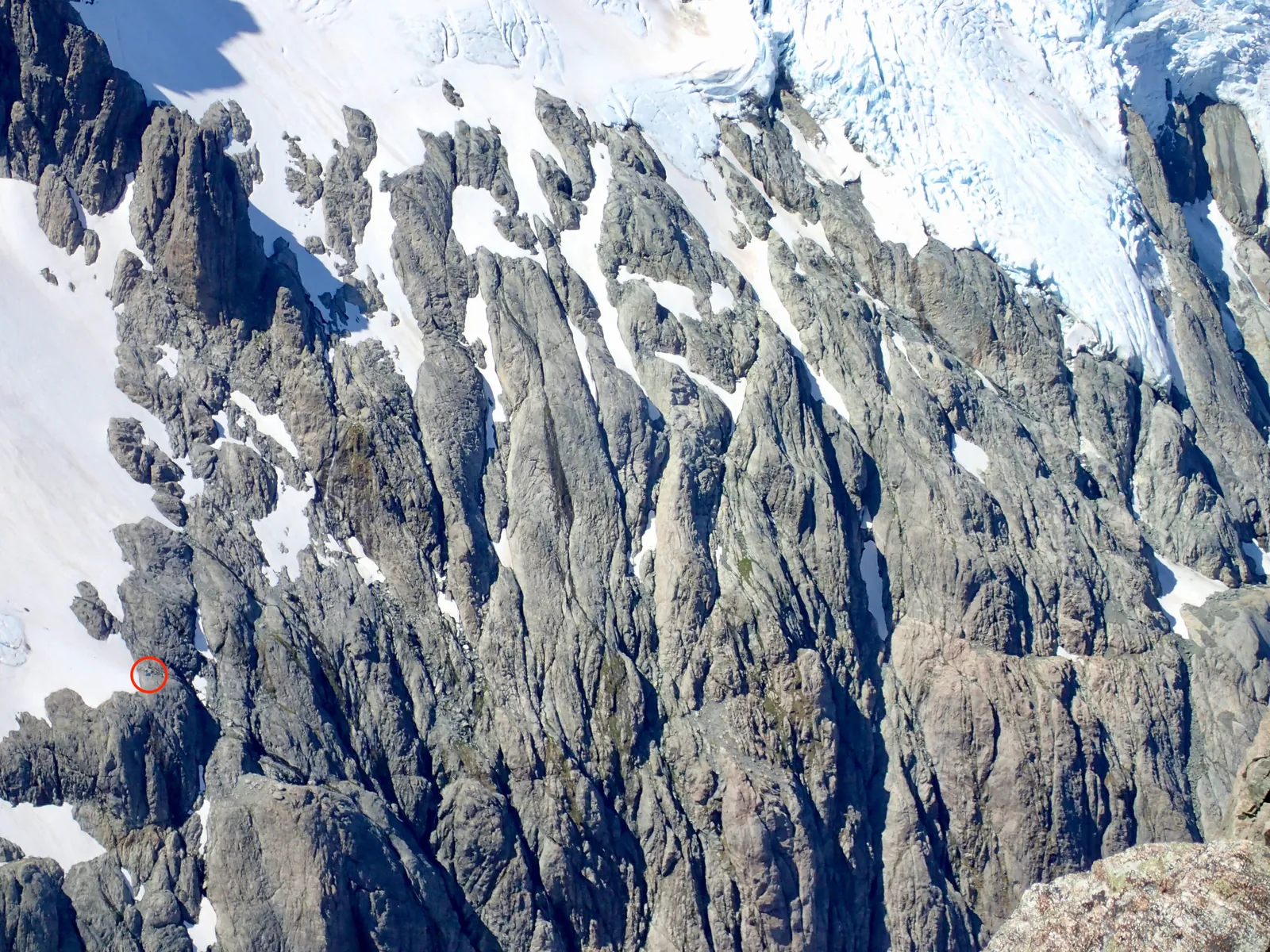 View towards the opposite rock face and our campsite, with our tent marked with a red circle.