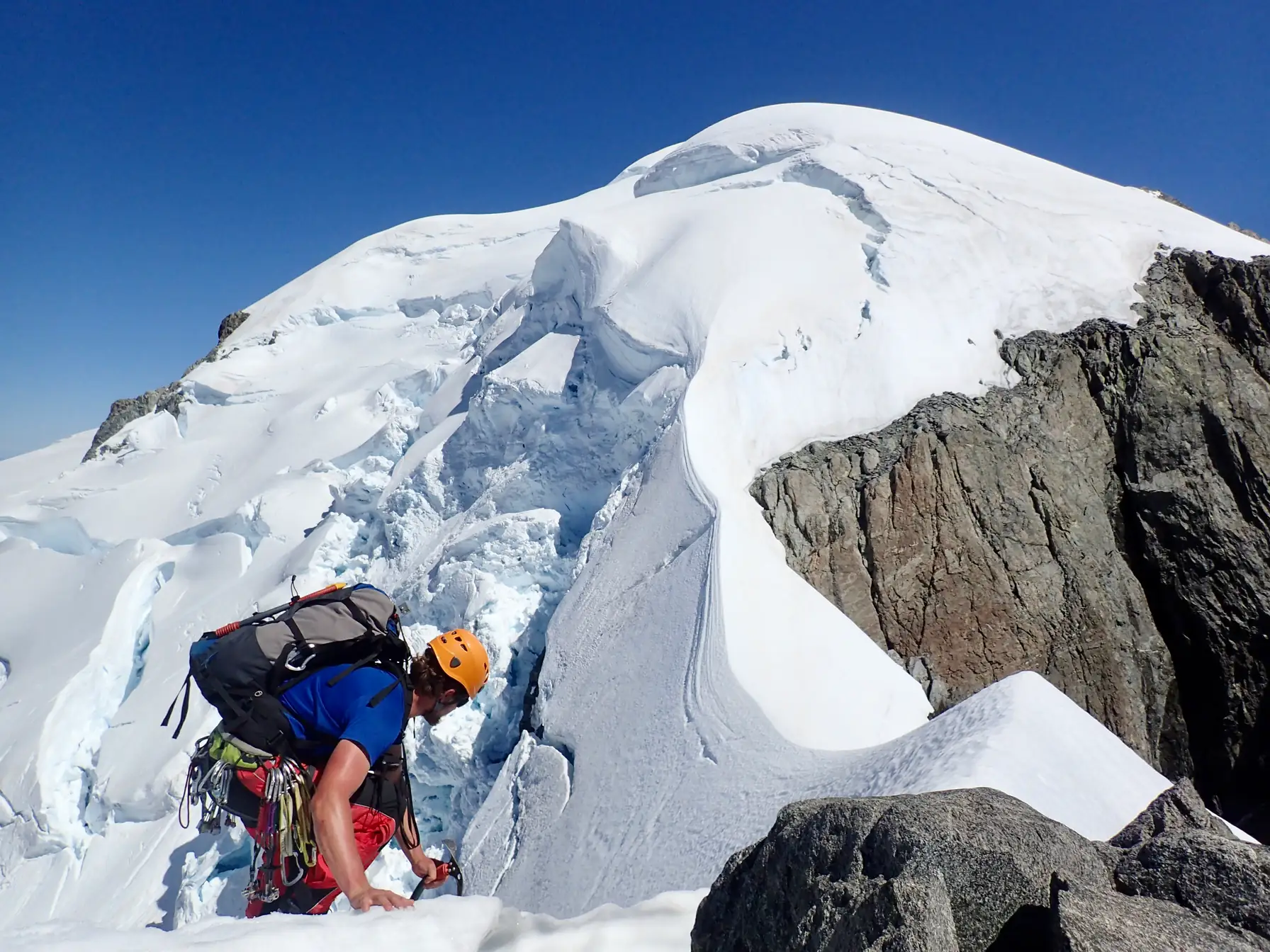 Willie on the South-East Ridge of Mount Tutoko, with seracs behind him below the summit snow cap.