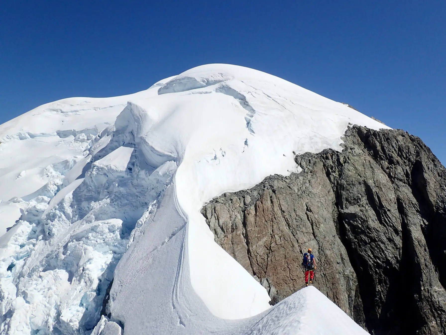 Willie on the South-East Ridge of Mount Tutoko, with seracs behind him below the summit snow cap.