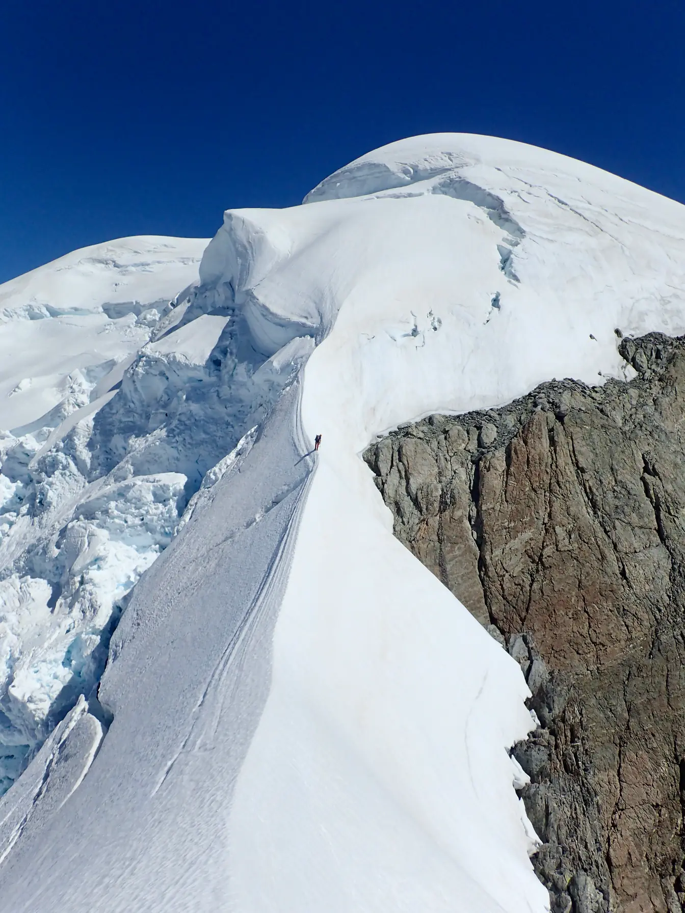 Willie on the South-East Ridge of Mount Tutoko, with seracs behind him below the summit snow cap.