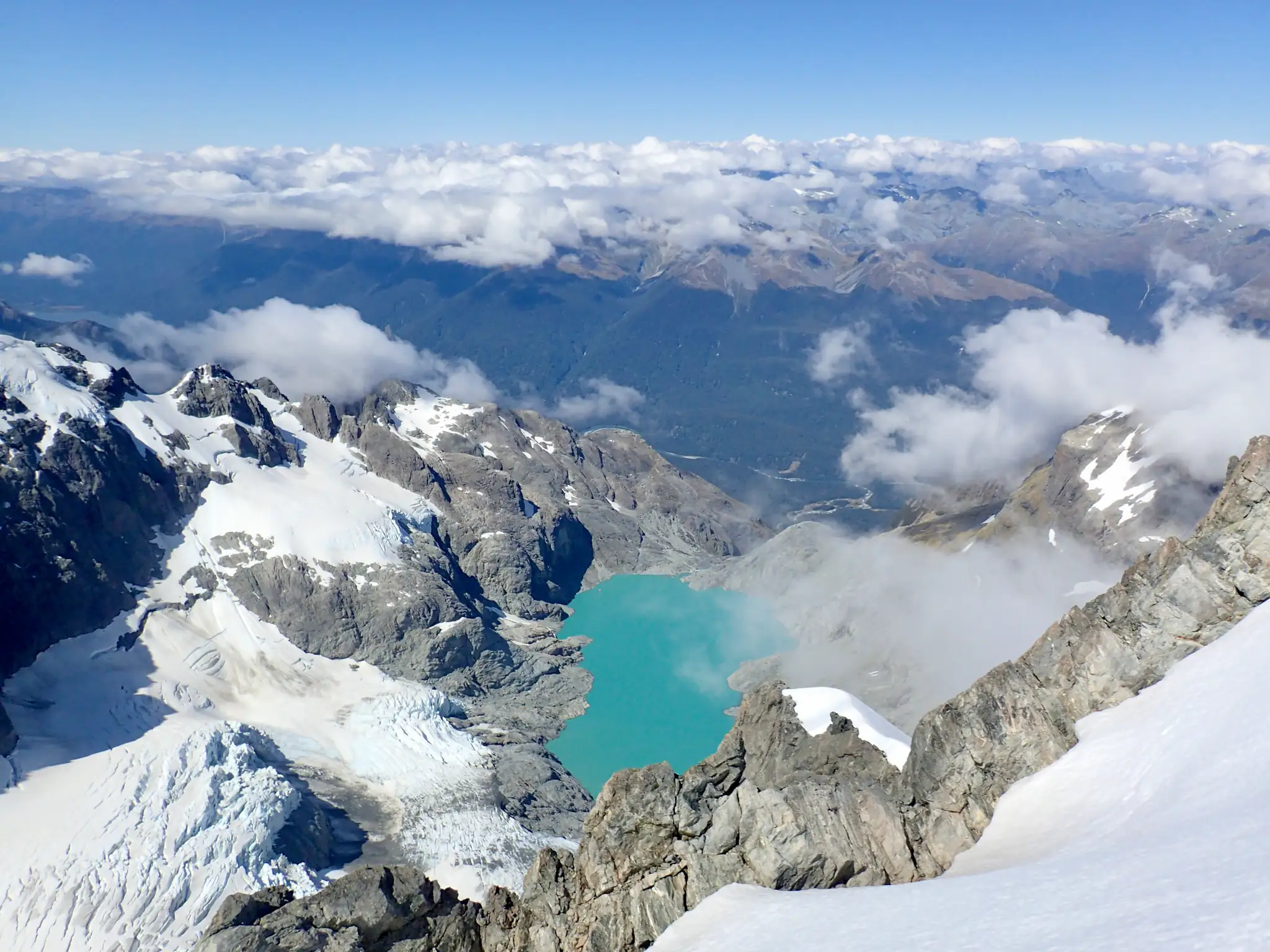 View of a lake and a valley from Mount Tutoko's ridge.